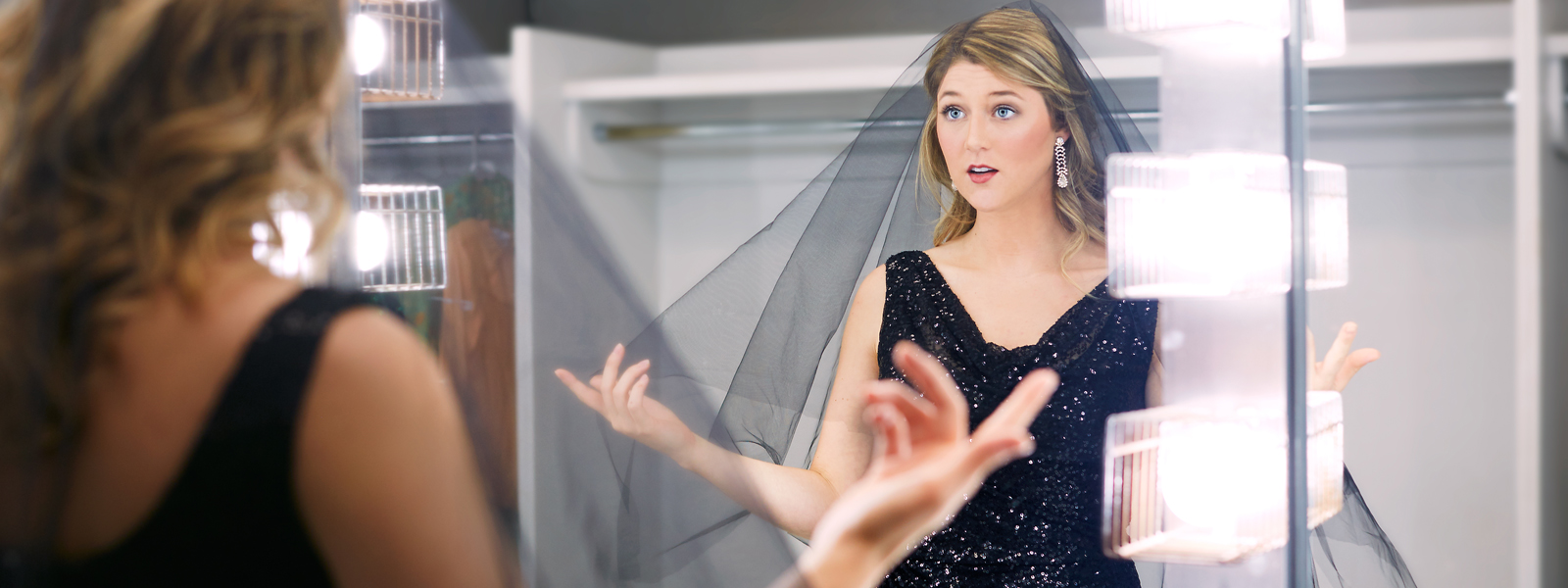 Female student rehearsing in a mirror.