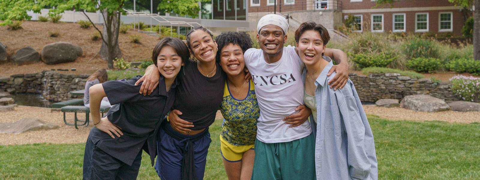 Group of UNCSA students standing together on campus