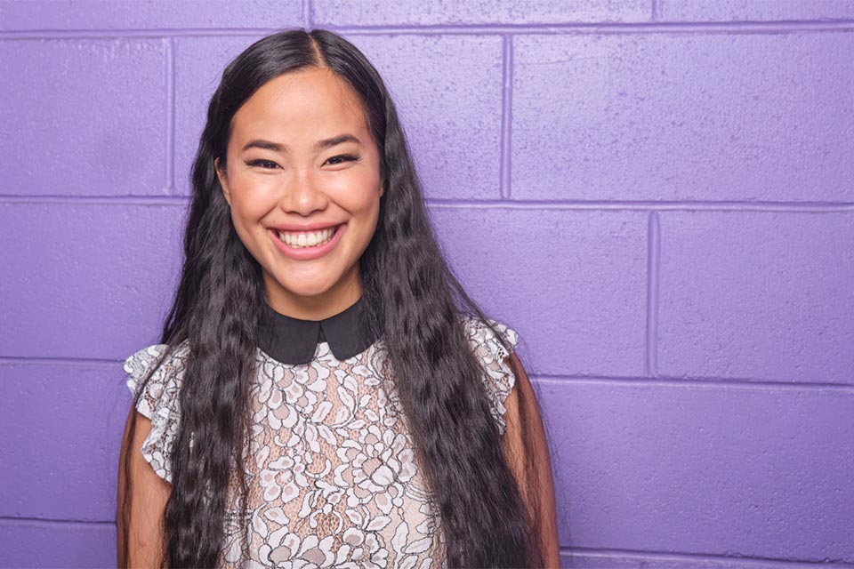 Isabelle Bushue headshot with purple background