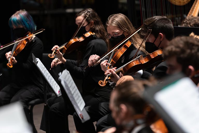 Violin students in an orchestra performance
