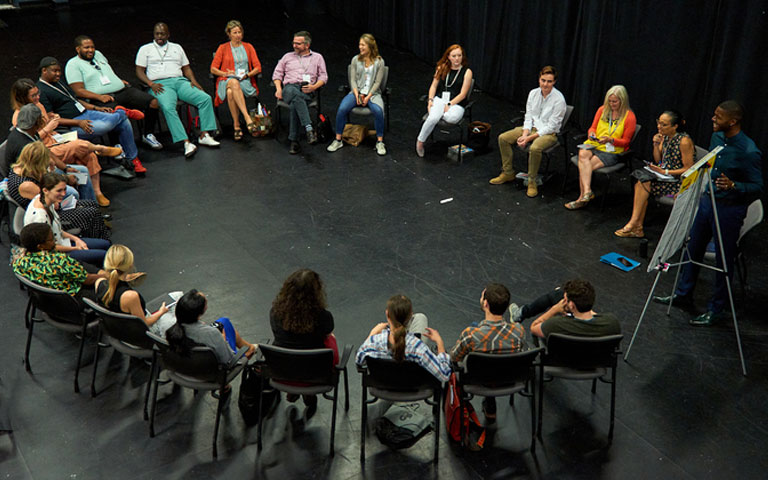 Sitting in chairs in a circle