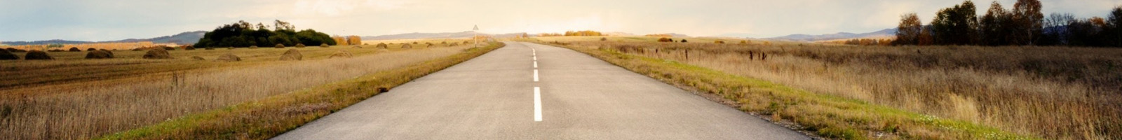 Country road with sunrise at the end