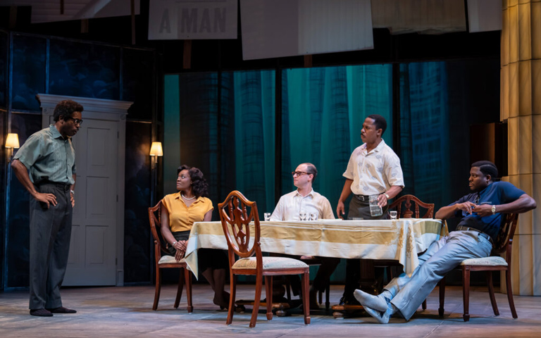 Actors perform on stage in a production